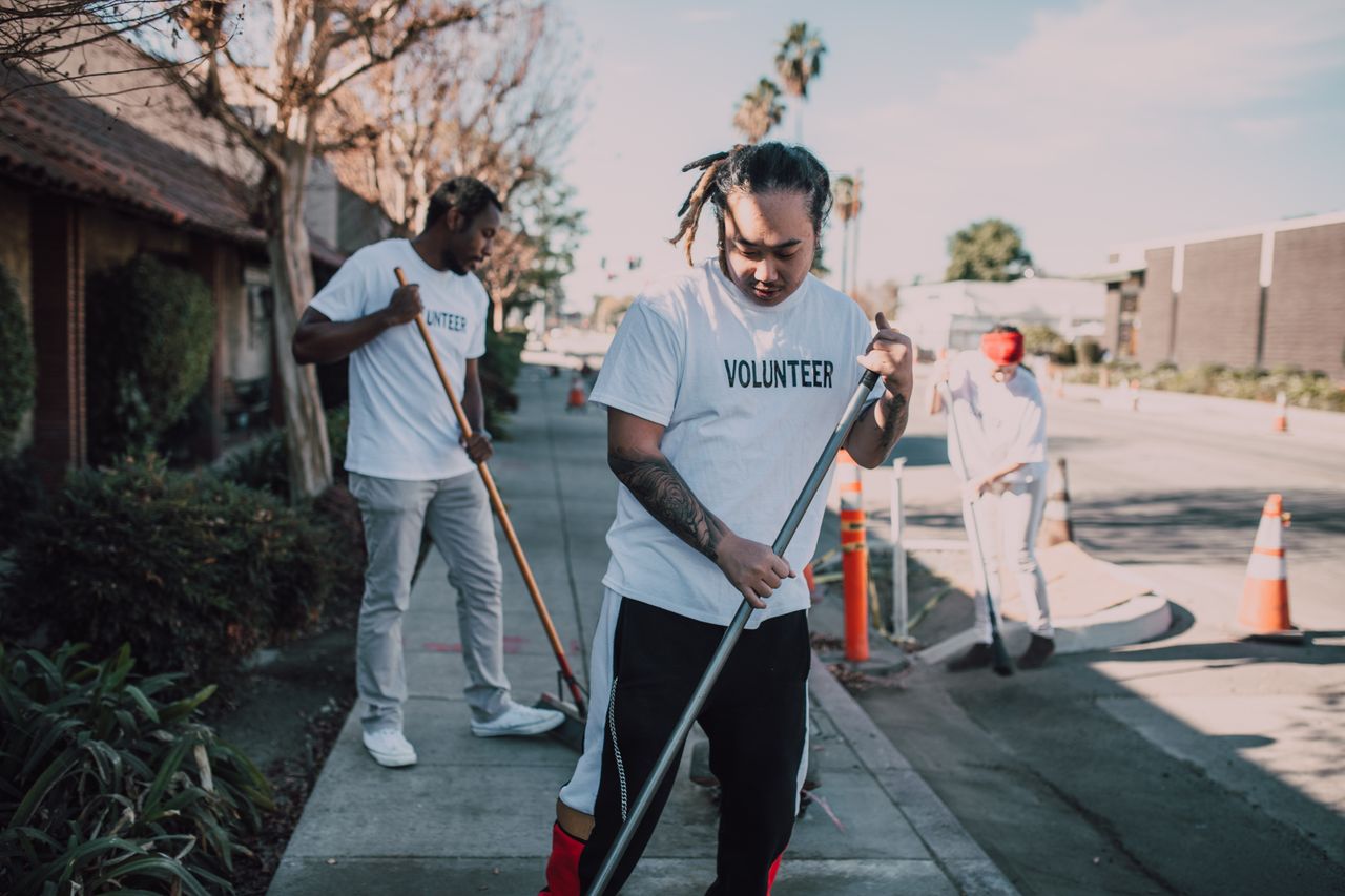 About Community volunteers cleaning up streets to promote environmental awareness and social good.